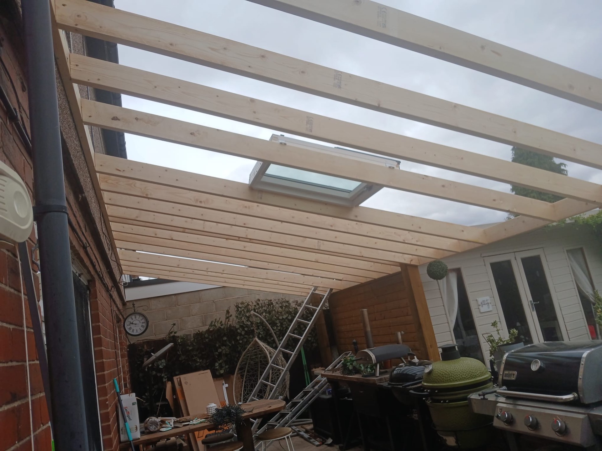 Timber canopy framework with skylight opening being built